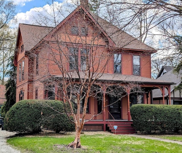 907 W Church St, Champaign, IL 61821 - view of front facade with a porch, a shingled roof, and a chimney
