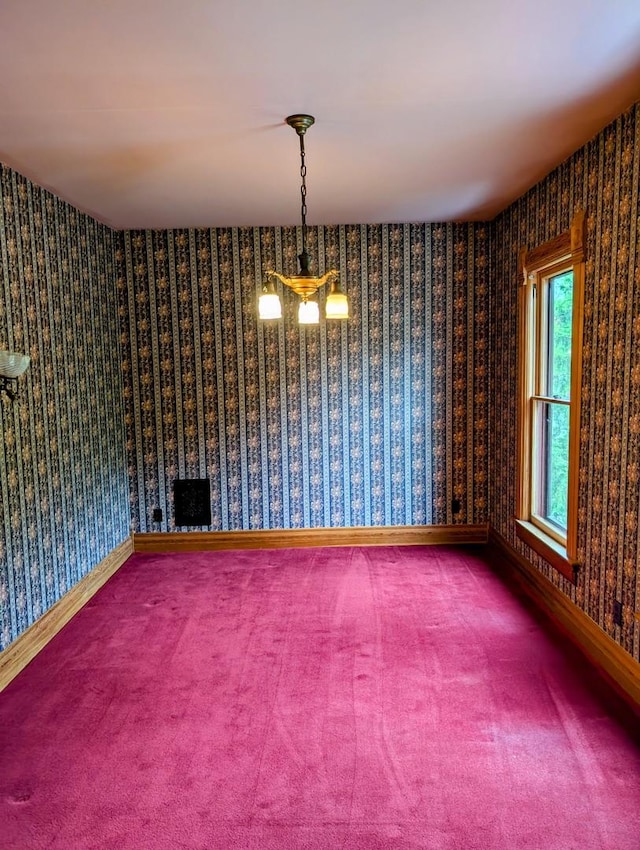 907 W Church St, Champaign, IL 61821 - spare room featuring carpet, baseboards, and wallpapered walls