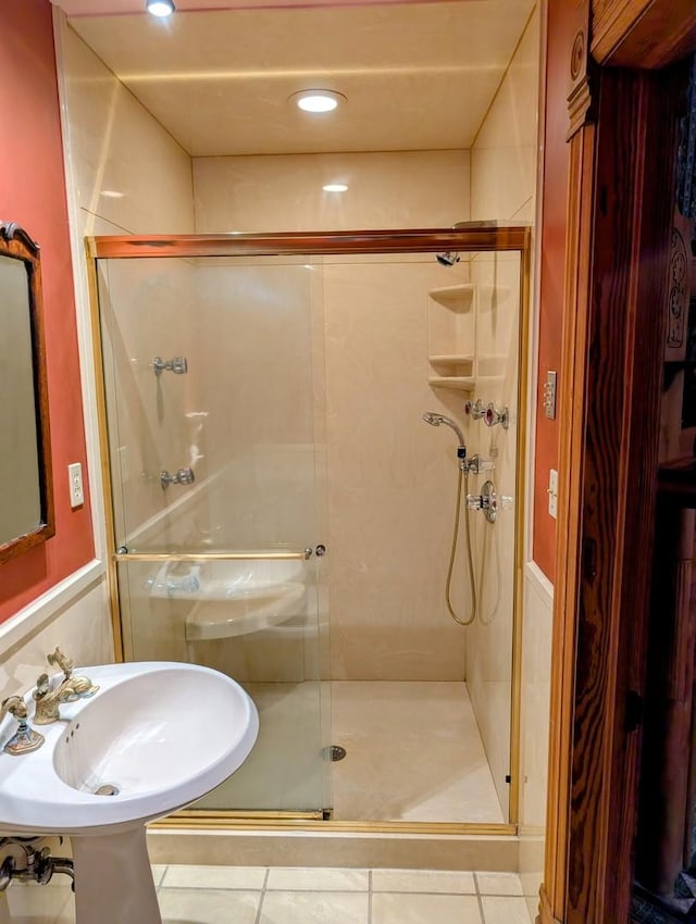 907 W Church St, Champaign, IL 61821 - bathroom with a stall shower, a sink, and tile patterned floors