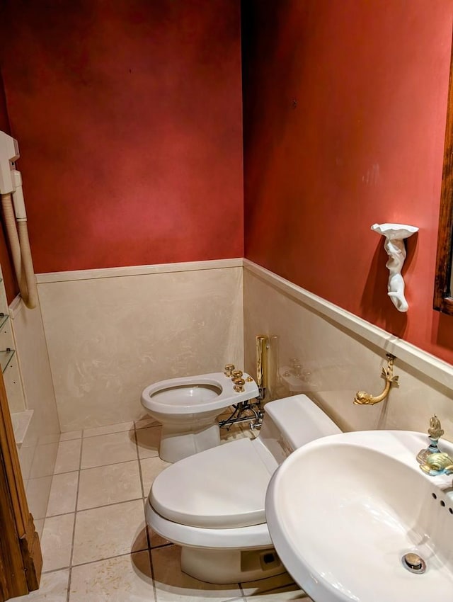 907 W Church St, Champaign, IL 61821 - half bathroom with toilet, a sink, and tile patterned floors