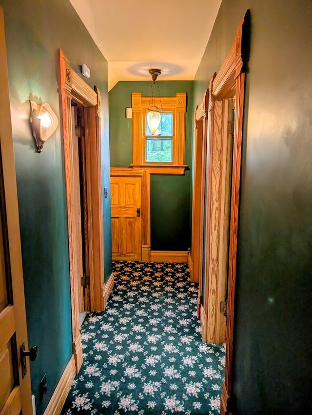 907 W Church St, Champaign, IL 61821 - corridor with carpet flooring, vaulted ceiling, and baseboards