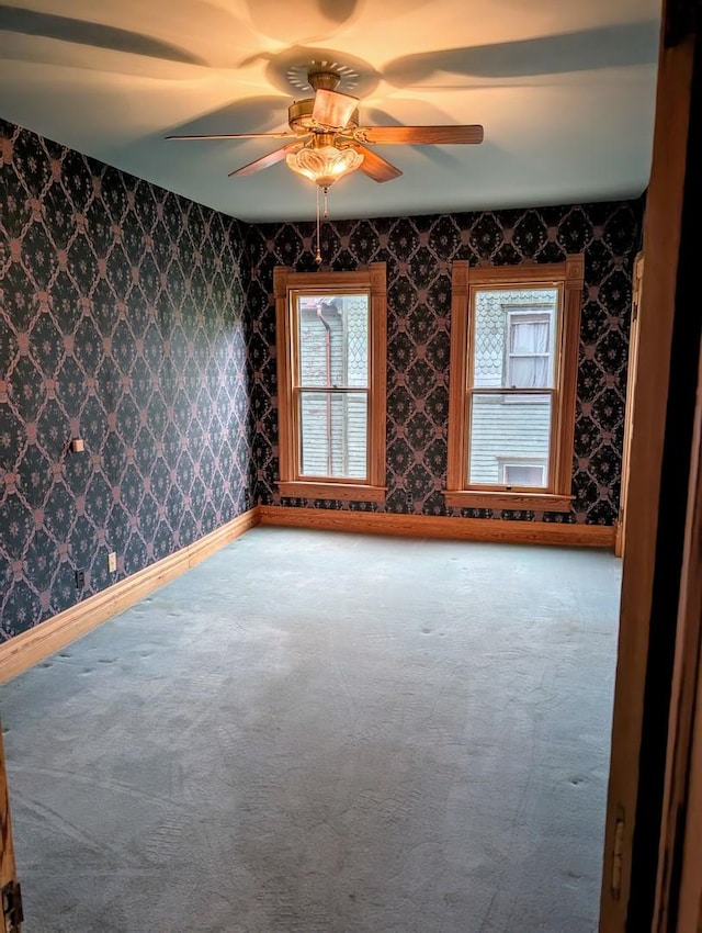 907 W Church St, Champaign, IL 61821 - spare room with carpet flooring, ceiling fan, and wallpapered walls