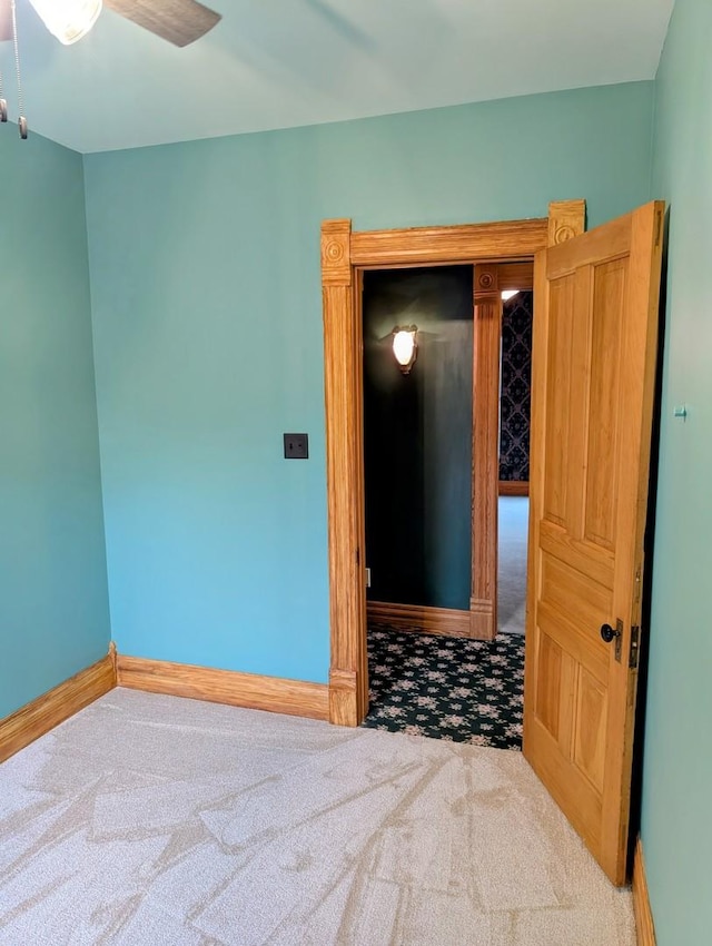 907 W Church St, Champaign, IL 61821 - carpeted spare room with baseboards and a ceiling fan