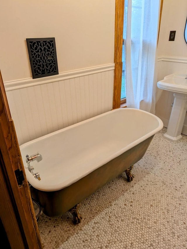 907 W Church St, Champaign, IL 61821 - bathroom featuring a wainscoted wall and a freestanding bath