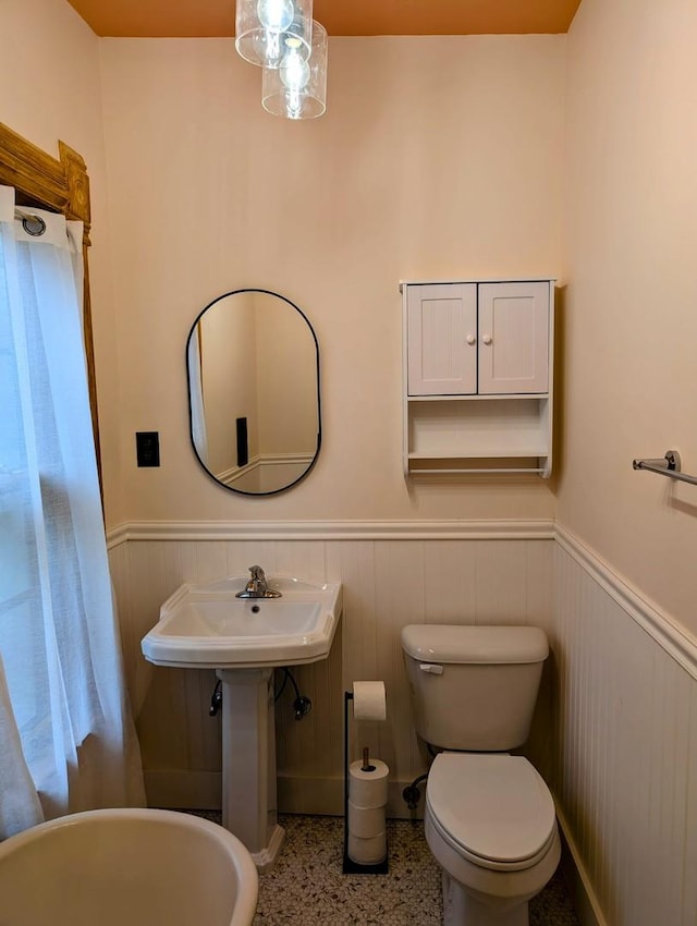 907 W Church St, Champaign, IL 61821 - half bath with wainscoting, toilet, speckled floor, and a sink