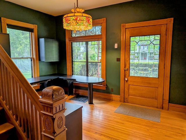 907 W Church St, Champaign, IL 61821 - entryway with light wood finished floors, plenty of natural light, stairway, and baseboards