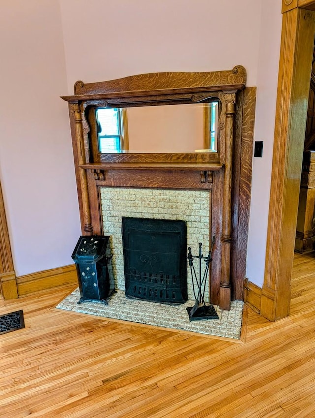 907 W Church St, Champaign, IL 61821 - detailed view of wood finished floors, baseboards, and a fireplace with flush hearth