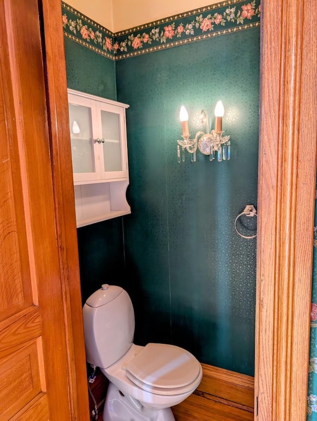 907 W Church St, Champaign, IL 61821 - bathroom featuring toilet, wood finished floors, and a chandelier