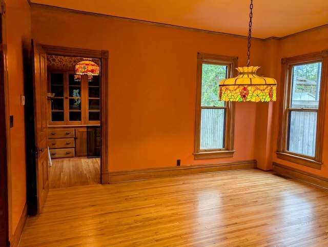 907 W Church St, Champaign, IL 61821 - unfurnished dining area with light wood-style floors, healthy amount of natural light, and baseboards