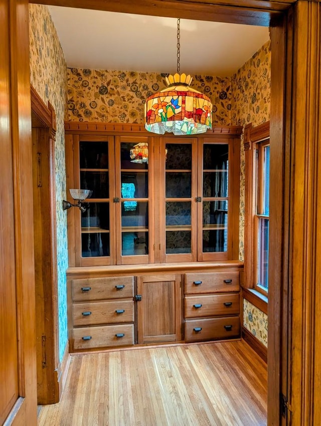 907 W Church St, Champaign, IL 61821 - unfurnished dining area featuring wallpapered walls and light wood-style flooring