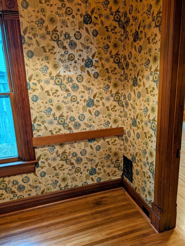 907 W Church St, Champaign, IL 61821 - detailed view of baseboards, wood finished floors, and wallpapered walls