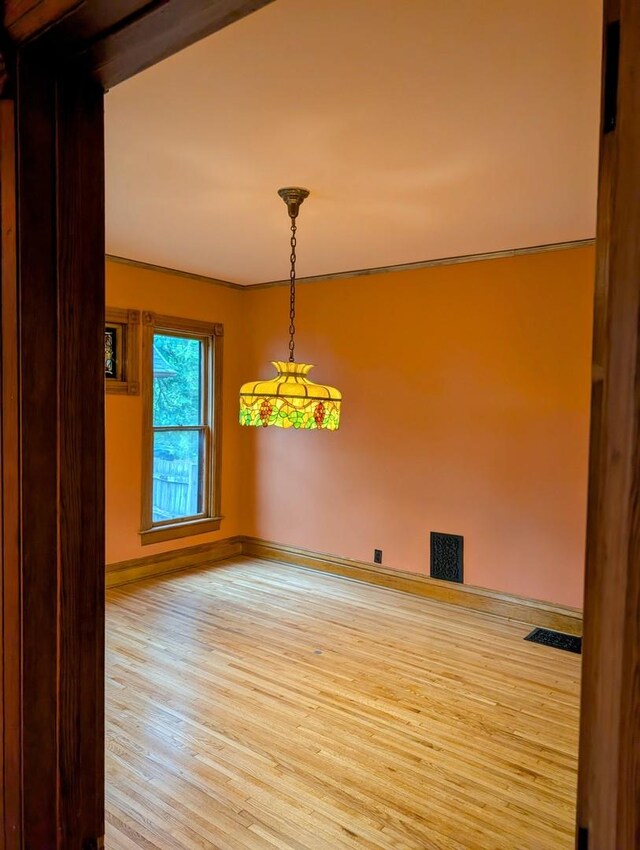 907 W Church St, Champaign, IL 61821 - unfurnished room with wood finished floors and baseboards