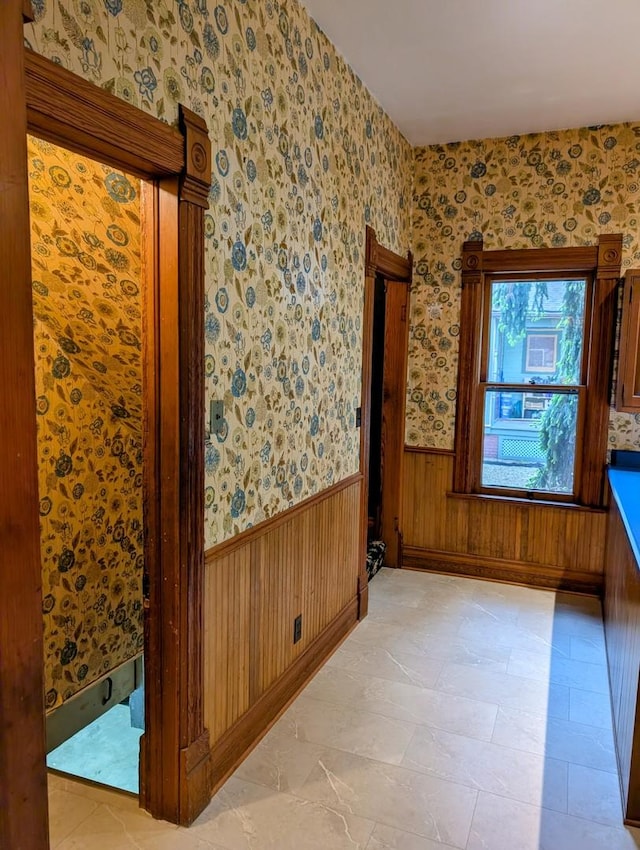 907 W Church St, Champaign, IL 61821 - empty room featuring wainscoting and wallpapered walls