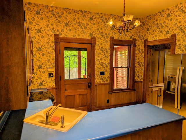 907 W Church St, Champaign, IL 61821 - entrance foyer with wallpapered walls, wainscoting, and a chandelier