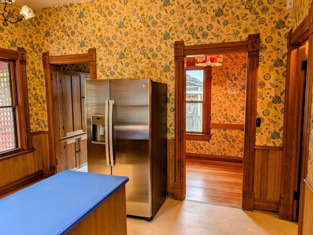 907 W Church St, Champaign, IL 61821 - kitchen with stainless steel fridge with ice dispenser, wallpapered walls, and a wainscoted wall