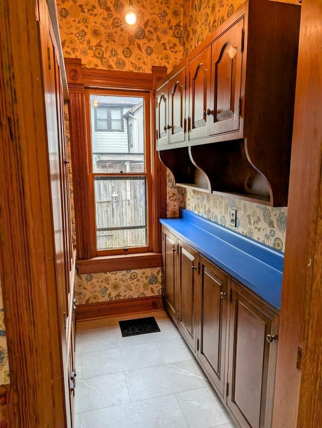 907 W Church St, Champaign, IL 61821 - kitchen featuring wallpapered walls, baseboards, and light tile patterned floors