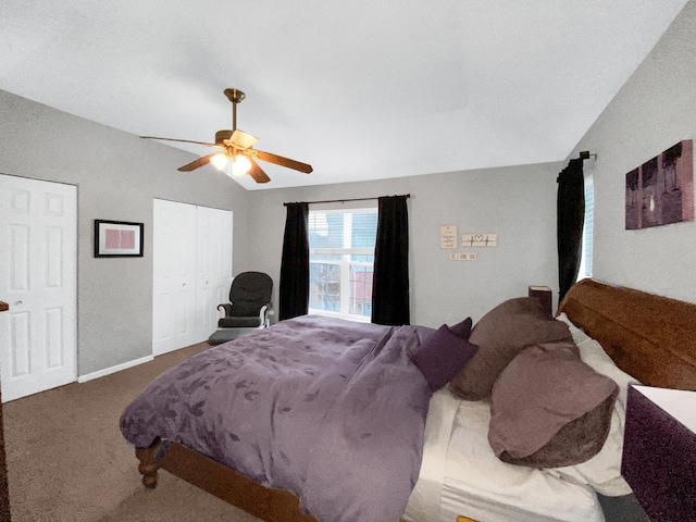 carpeted bedroom with vaulted ceiling and a ceiling fan
