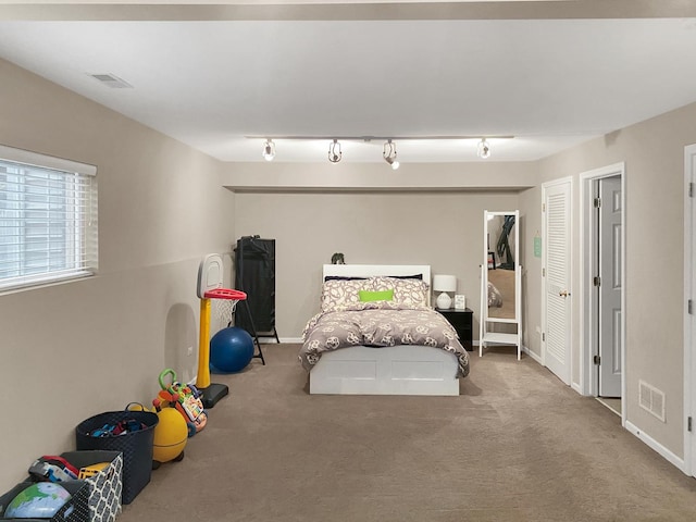 carpeted bedroom with baseboards and visible vents