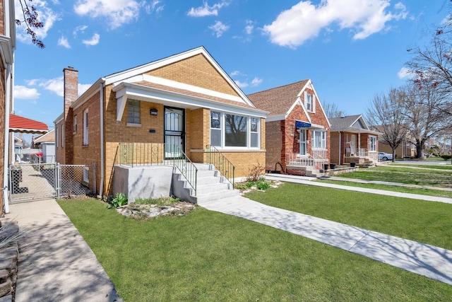 bungalow-style home with brick siding, a front yard, a chimney, and a gate