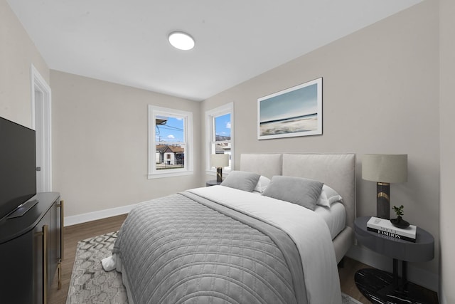 bedroom with baseboards and wood finished floors