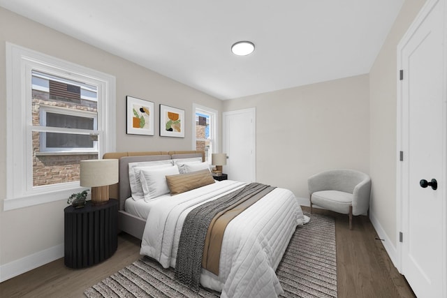 bedroom with wood finished floors and baseboards