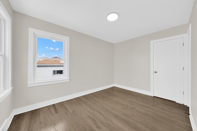 empty room with wood finished floors and baseboards