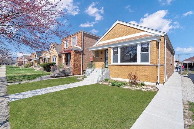 view of front of property with a front lawn and brick siding