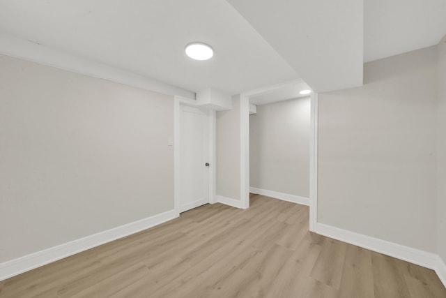 finished below grade area featuring recessed lighting, light wood-style floors, and baseboards