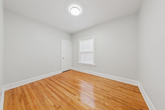 empty room featuring wood finished floors and baseboards