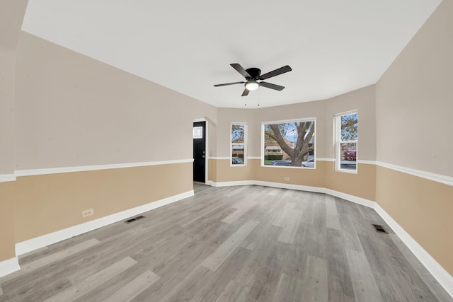 3435 W 71st Pl, Chicago, IL 60629 - unfurnished room with wood finished floors, visible vents, a ceiling fan, and baseboards