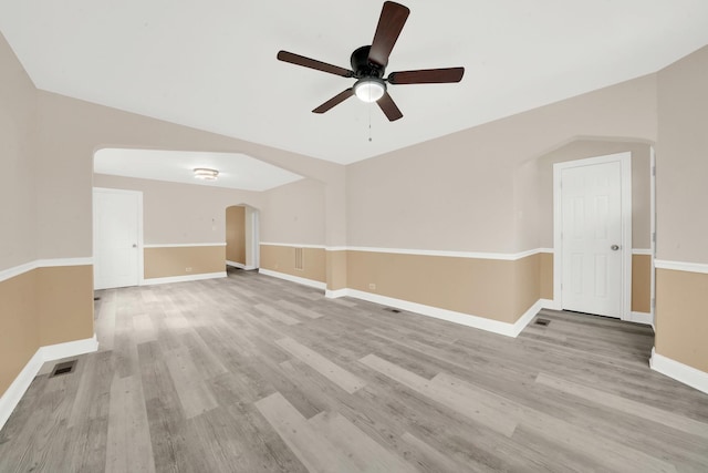 3435 W 71st Pl, Chicago, IL 60629 - empty room featuring visible vents, ceiling fan, light wood-style floors, baseboards, and arched walkways