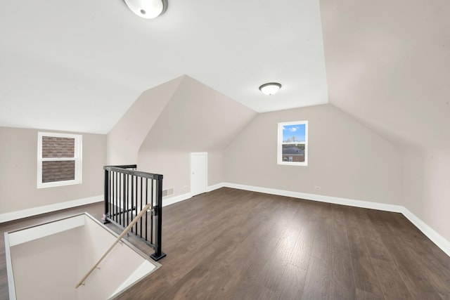 3435 W 71st Pl, Chicago, IL 60629 - additional living space with lofted ceiling, dark wood-type flooring, visible vents, and baseboards