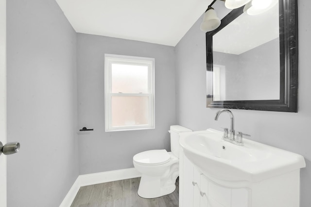 3435 W 71st Pl, Chicago, IL 60629 - bathroom featuring baseboards, wood finished floors, toilet, and vanity