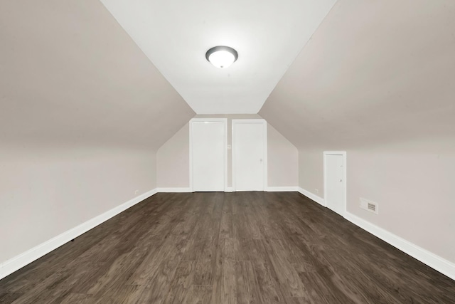3435 W 71st Pl, Chicago, IL 60629 - additional living space with dark wood finished floors, baseboards, visible vents, and lofted ceiling