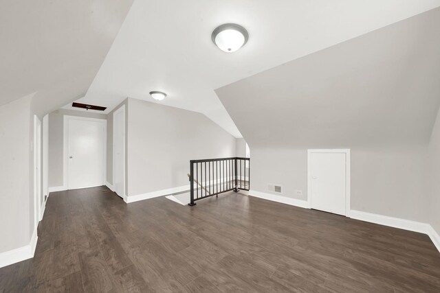 3435 W 71st Pl, Chicago, IL 60629 - additional living space with lofted ceiling, visible vents, wood finished floors, and baseboards