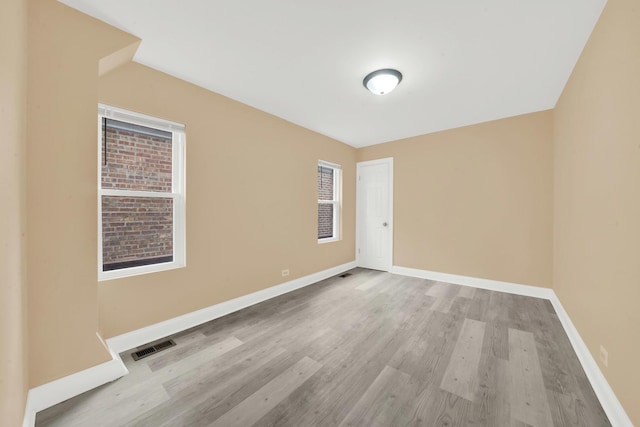 3435 W 71st Pl, Chicago, IL 60629 - spare room with visible vents, wood finished floors, and baseboards