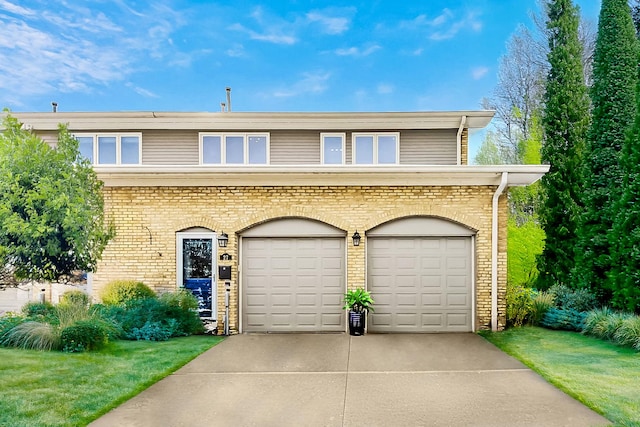 27 Rienzi Ln, Highwood, IL 60040 - view of front of property with brick siding, a garage, and concrete driveway