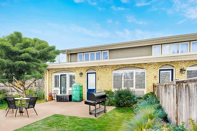 27 Rienzi Ln, Highwood, IL 60040 - back of house with brick siding, fence, and a patio area