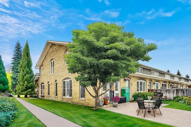 27 Rienzi Ln, Highwood, IL 60040 - rear view of property with a lawn, brick siding, and a patio