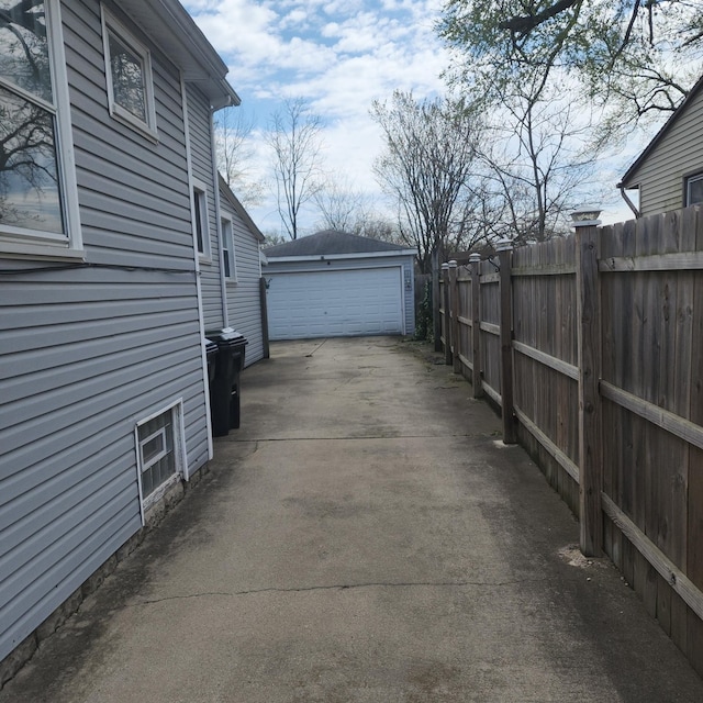 14951 Riverside Dr, South Holland, IL 60473 - view of property exterior featuring a garage, an outdoor structure, and concrete driveway