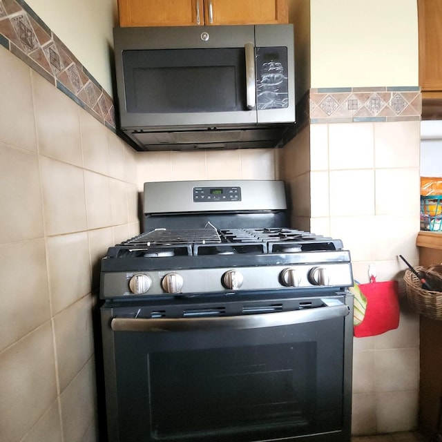 14951 Riverside Dr, South Holland, IL 60473 - kitchen featuring appliances with stainless steel finishes, tile walls, and decorative backsplash
