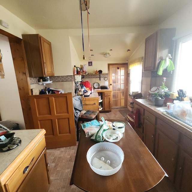 14951 Riverside Dr, South Holland, IL 60473 - kitchen with plenty of natural light, decorative backsplash, light countertops, and brown cabinetry