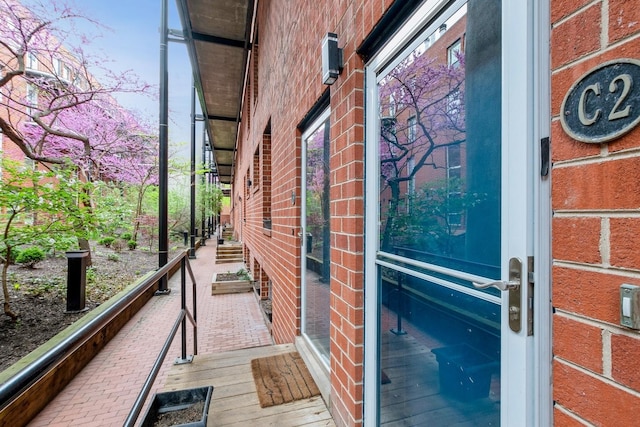 entrance to property featuring brick siding