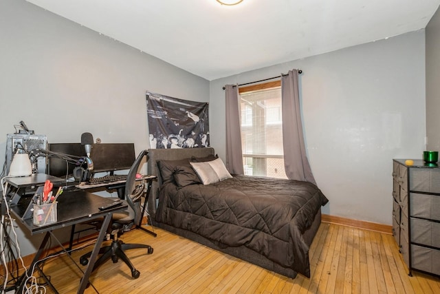 bedroom featuring wood-type flooring and baseboards