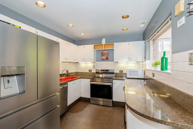 kitchen with white cabinets, appliances with stainless steel finishes, and a sink