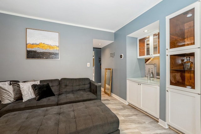 living room with baseboards, ornamental molding, light wood-style flooring, and recessed lighting