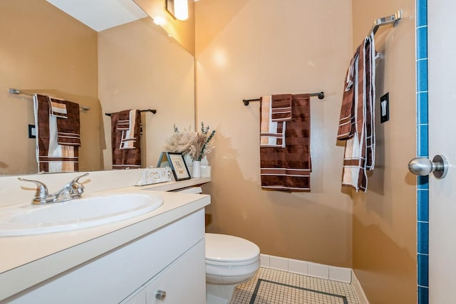 bathroom featuring toilet, baseboards, tile patterned flooring, and vanity