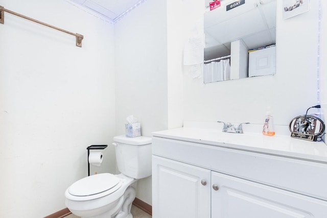 full bath featuring baseboards, toilet, and vanity