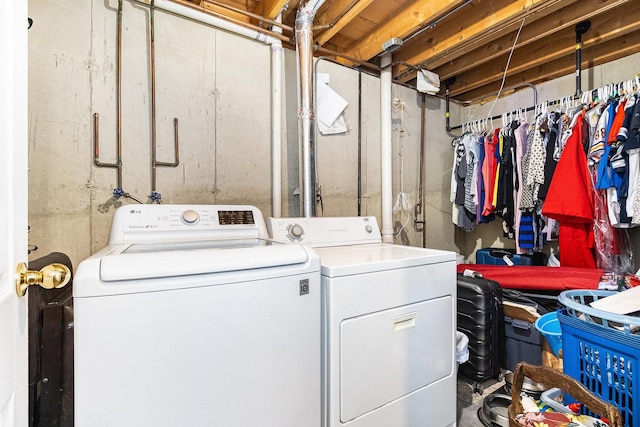 clothes washing area with washing machine and dryer and laundry area