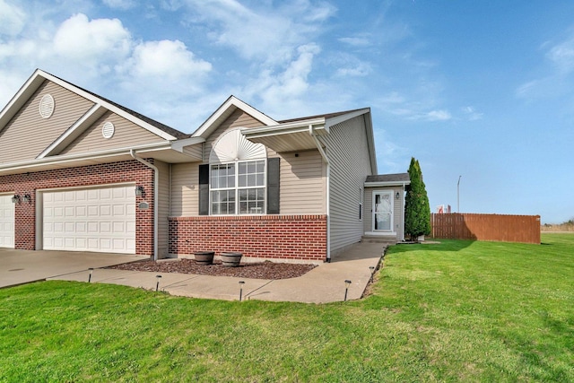 141 Scott Ave, Oglesby, IL 61348 - ranch-style house with concrete driveway, a front lawn, fence, a garage, and brick siding